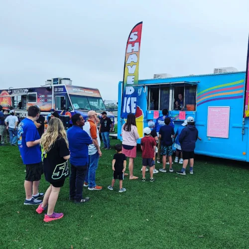 Casey's team member serving a crowd of customers at the food truck window
