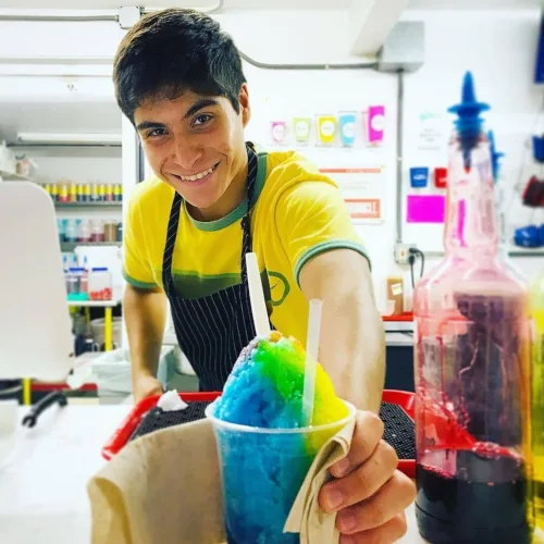 Casey's team member behind the counter holding a finished snowball